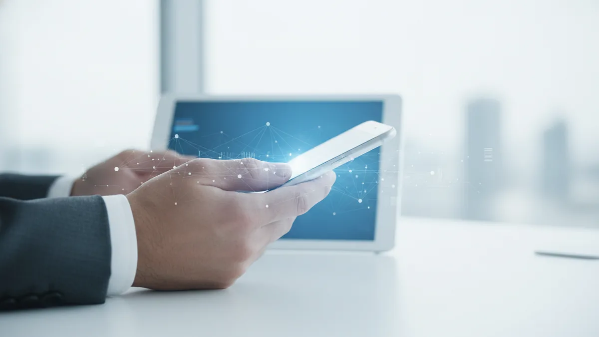 Hands holding a phone to send or receive money using a personal payment app